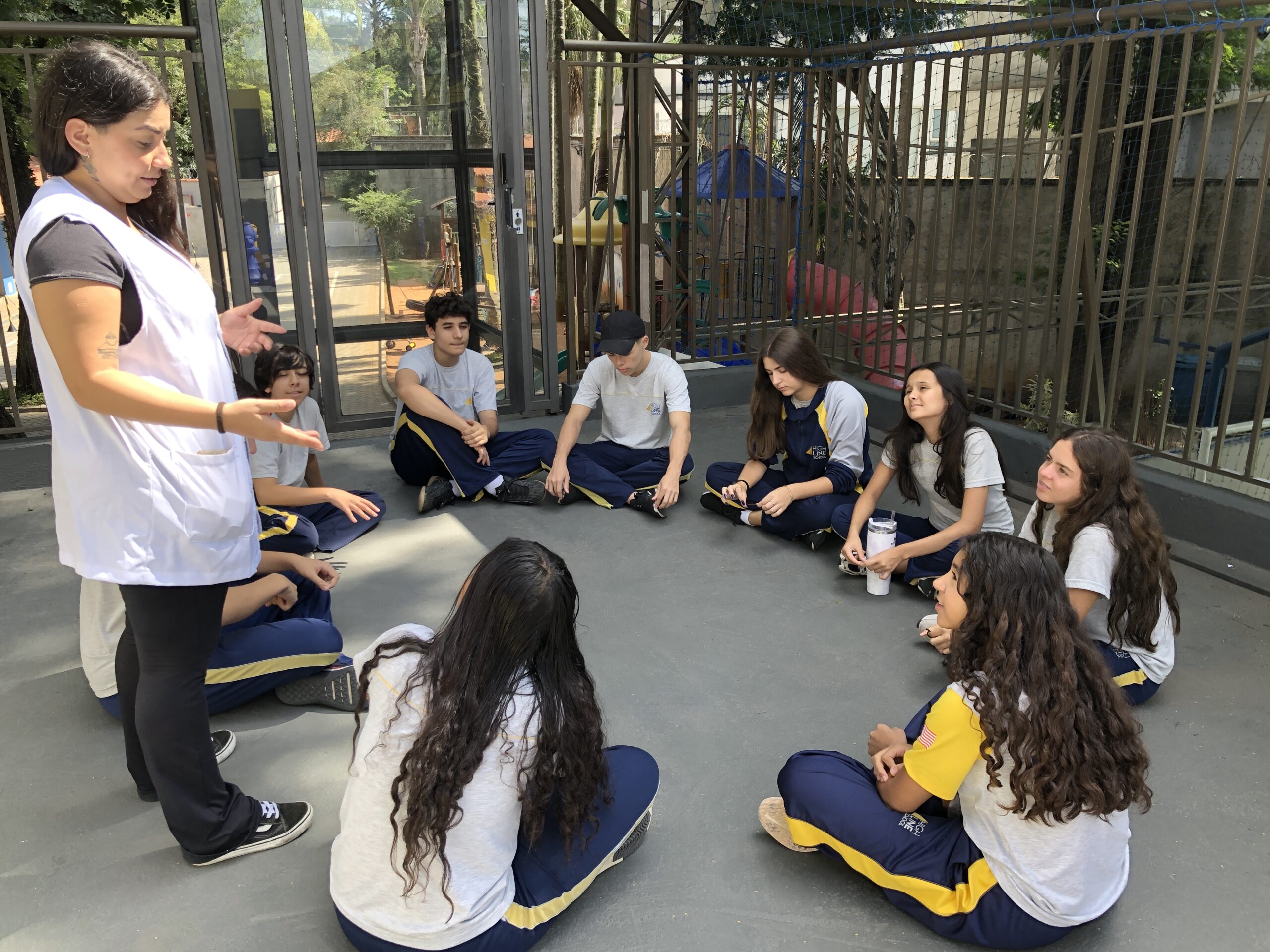 Crianças aprendendo em ambiente bilíngue com elementos das culturas brasileira e americana, promovendo a educação multiculturalismo na escola.